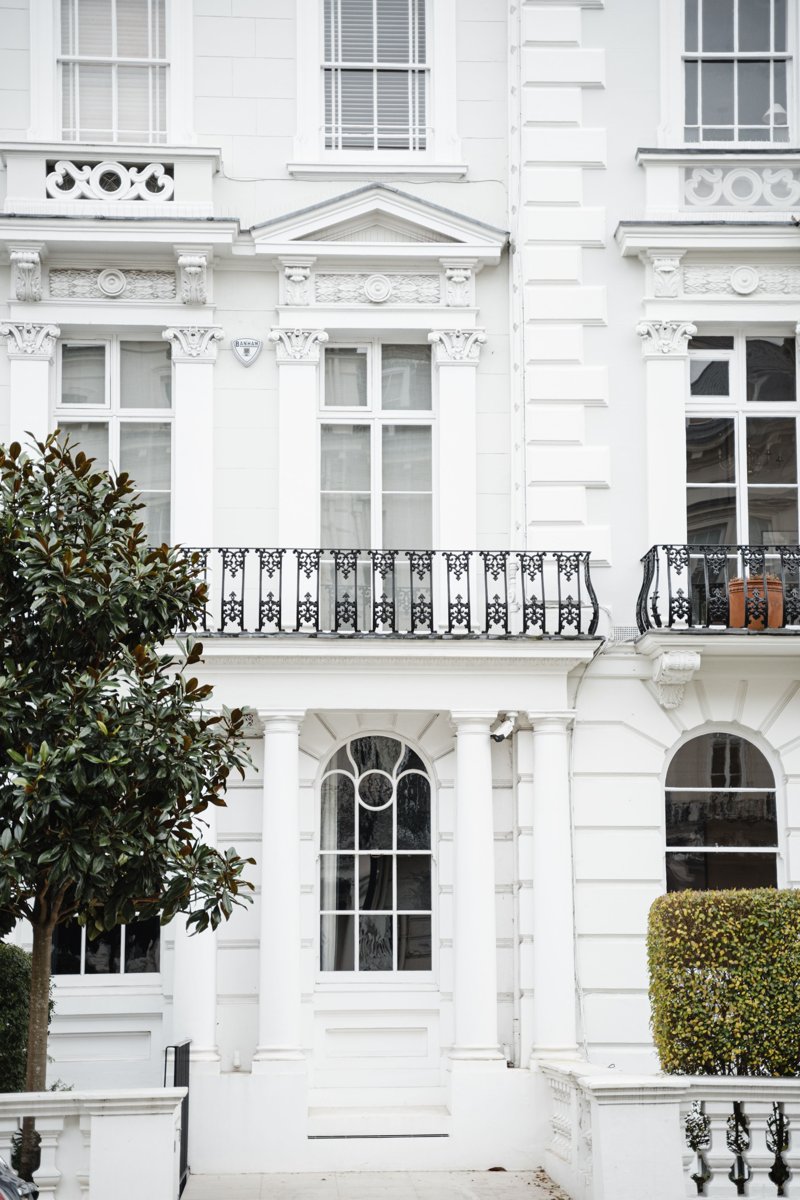 Elegant white London townhouse with iron balconies
